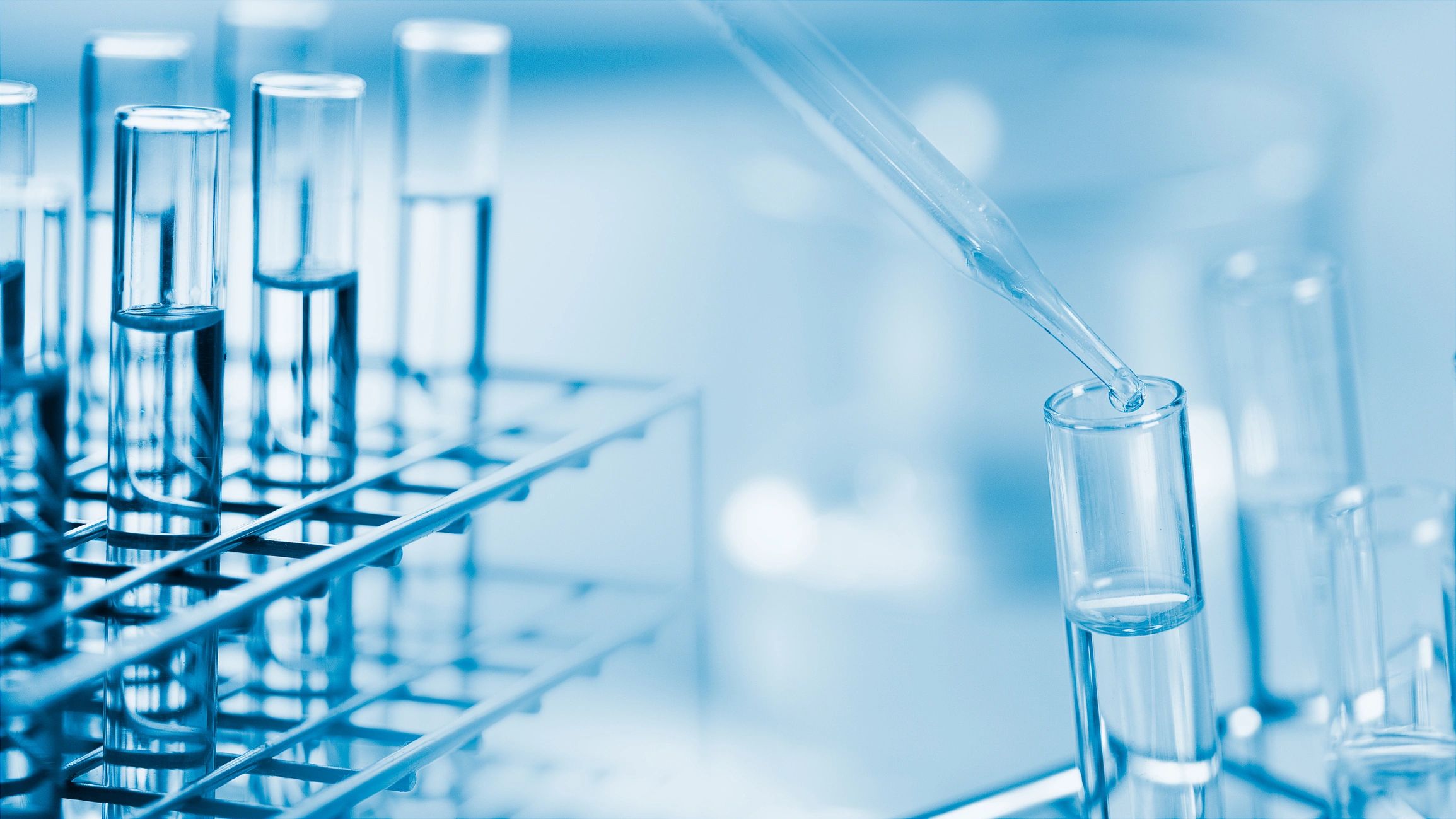 Dropping chemical liquid into a test tube in a research laboratory
