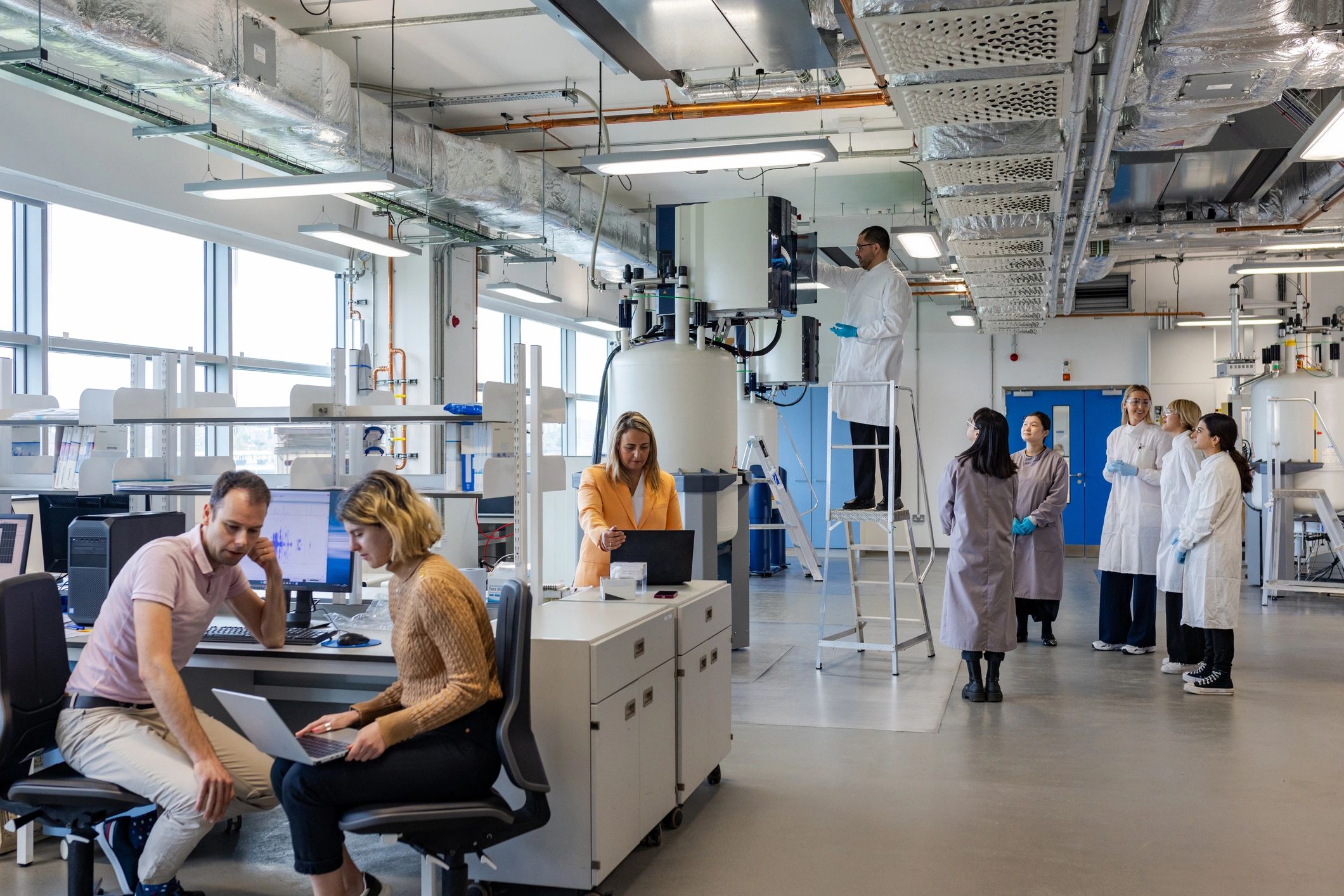 Research team reviewing test data in a laboratory
